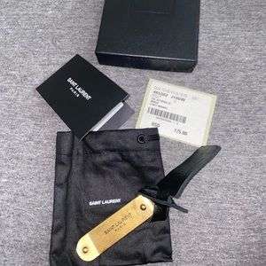 Gold colored YSL money clip